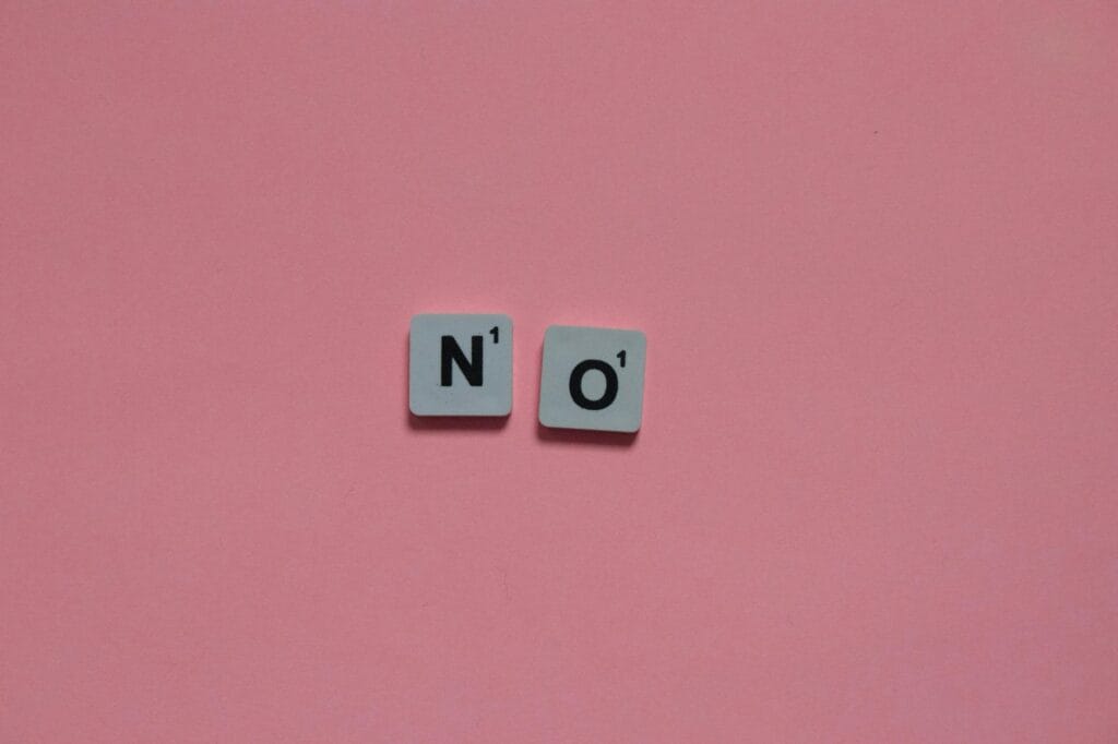 Letters N and O from a word game on a pink background. Minimalist and playful.