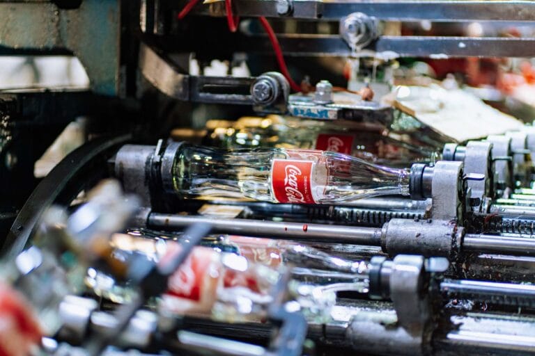 High-quality glass bottles being processed on a factory production line.