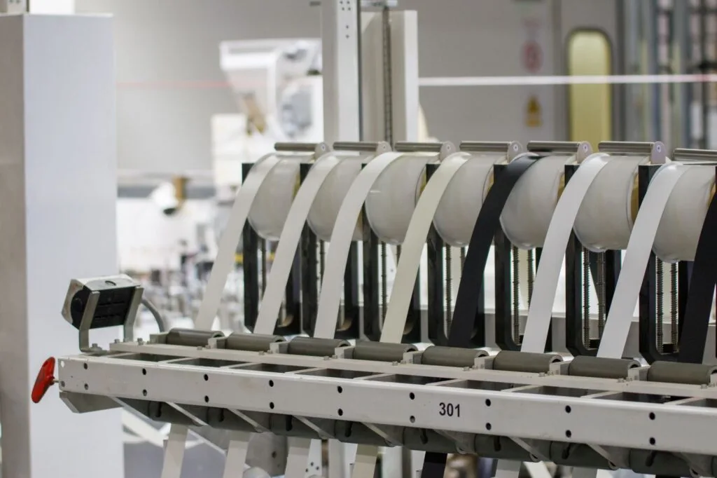 Modern industrial machine in operation in a manufacturing facility showcasing advanced technology.