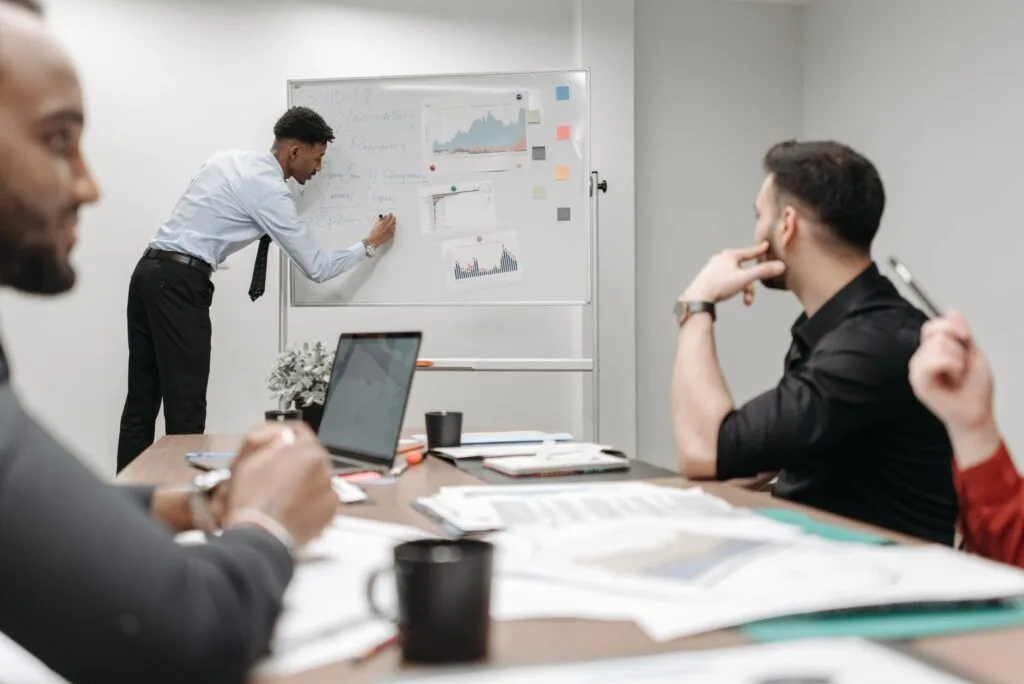 Colleagues in a business meeting discussing data and strategies at the office.