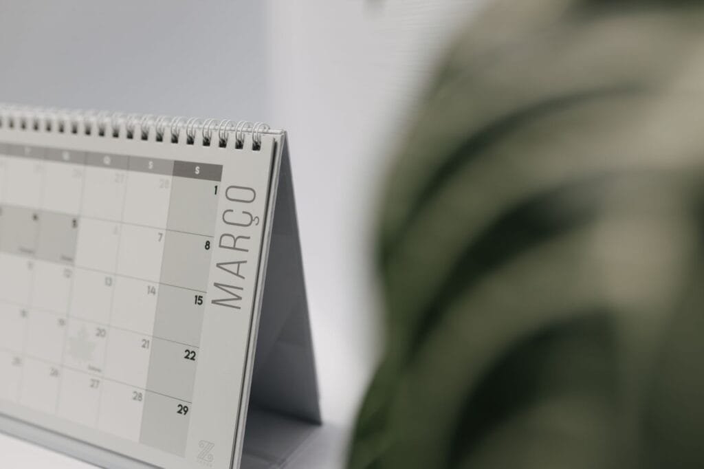 A close-up shot of a desk calendar open on March, with a soft, minimalistic background.