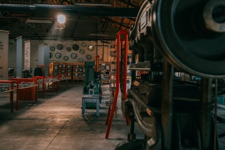A rustic industrial workshop filled with vintage machinery and tools.