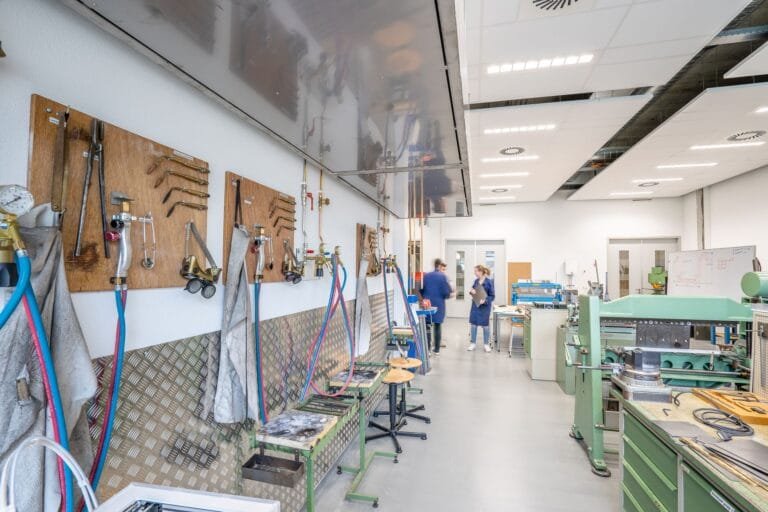 Bright, spacious workshop showcasing machinery and tools for industrial use.